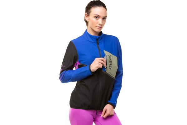 Model wearing the ronhill women's tech Gortex Windstopper Jacket, front view with zip closed