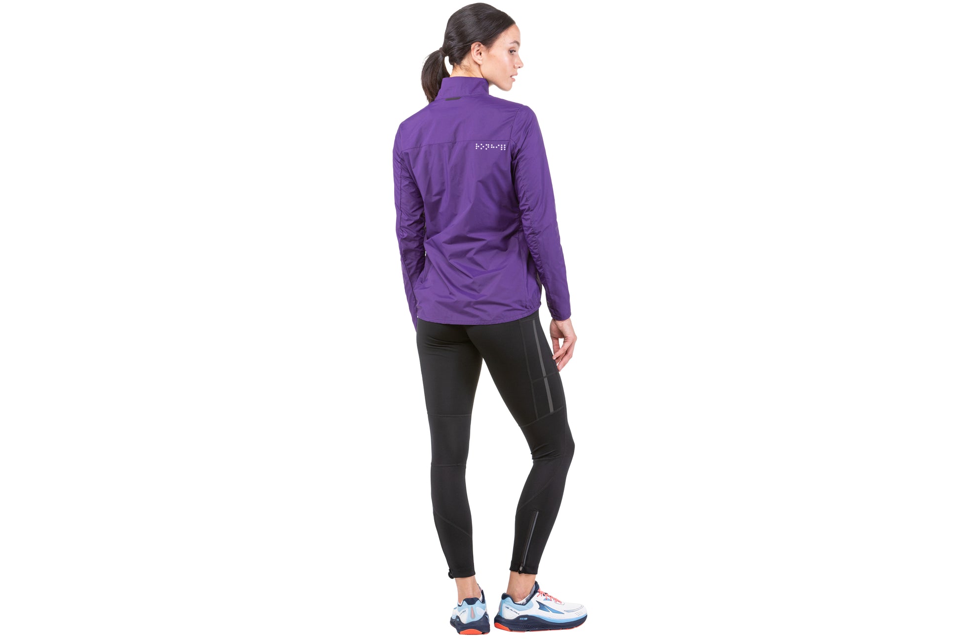 Women's Jacket - Women's Tech LTW Jacket by Ronhill. This jacket is light with a perfect balance of breathability and wind resistance and will keep you protected during days when it's drizzly and gusty. This jacket is in an imperial ultra violet colour. The jacket in this picture is a back view shown by a person wearing it..