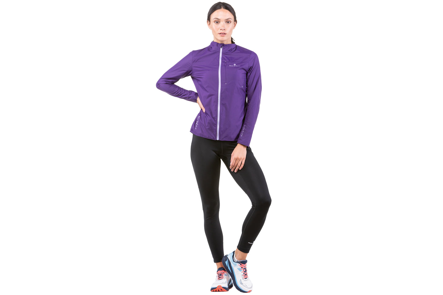 Women's Jacket - Women's Tech LTW Jacket by Ronhill. This jacket is light with a perfect balance of breathability and wind resistance and will keep you protected during days when it's drizzly and gusty. This jacket is in an imperial ultra violet colour. The jacket in this picture is a front view showing a person wearing it.