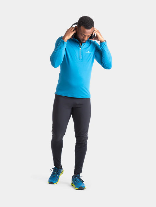 Ronhill's men's running tech half zip long sleeved t-shirt. Prussian Blue with willow logo. Front View on model.